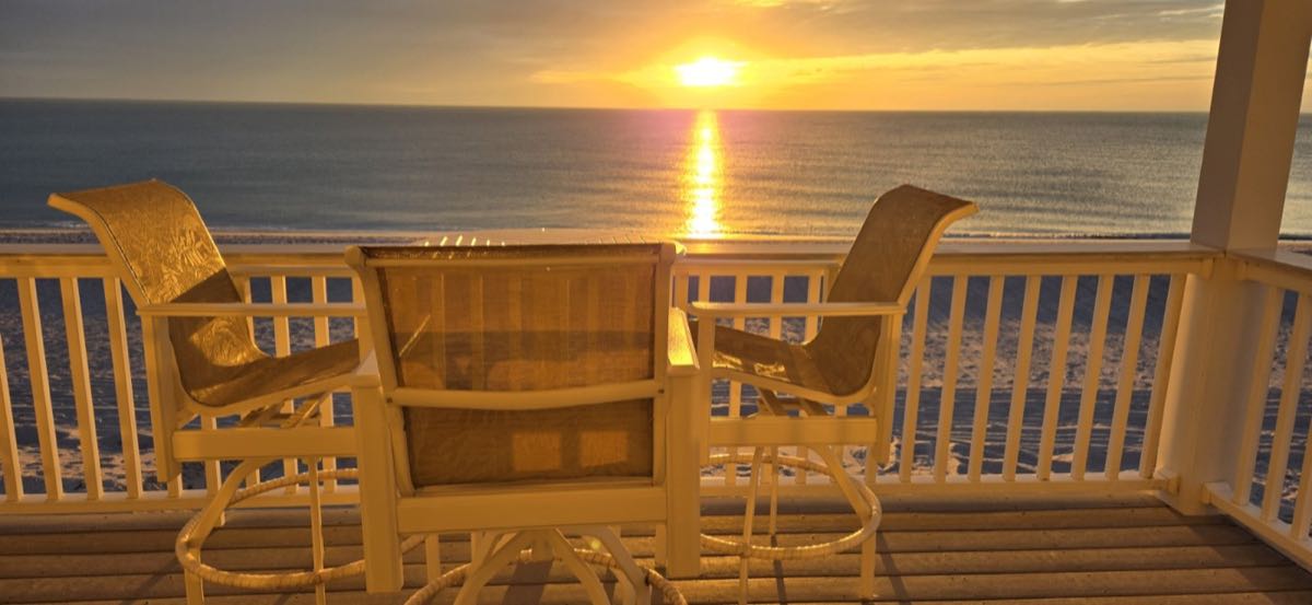 Sun setting over the Gulf from the covered deck